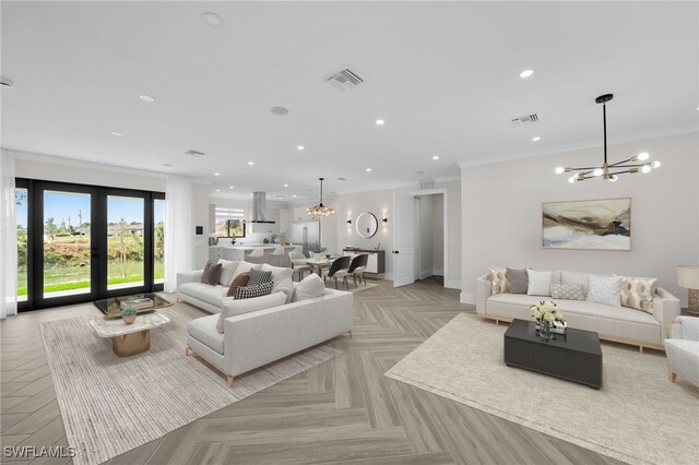 living room featuring ornamental molding, recessed lighting, visible vents, and a notable chandelier