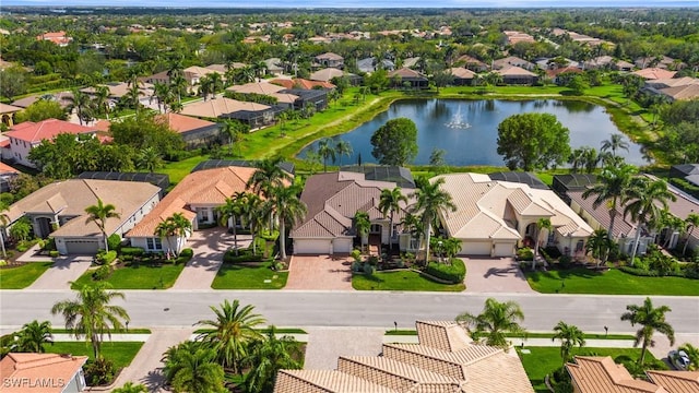 birds eye view of property featuring a water view and a residential view