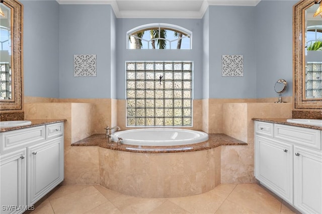 full bathroom featuring tile patterned floors, two vanities, crown molding, and a bath