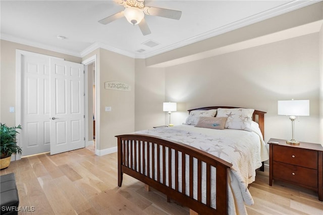 bedroom featuring light wood-type flooring, baseboards, ornamental molding, and a ceiling fan