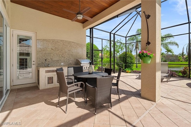 view of patio featuring glass enclosure, outdoor dining space, grilling area, and area for grilling