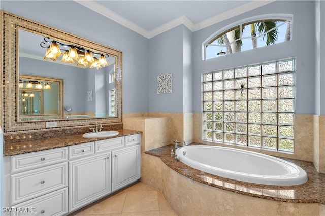 bathroom with a garden tub, vanity, crown molding, and tile patterned floors