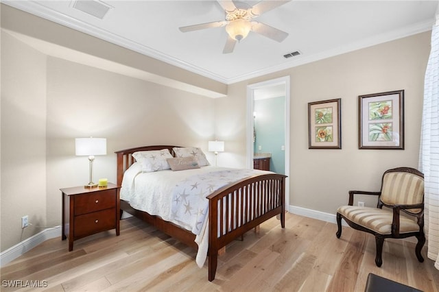 bedroom with light wood finished floors, visible vents, ornamental molding, connected bathroom, and baseboards