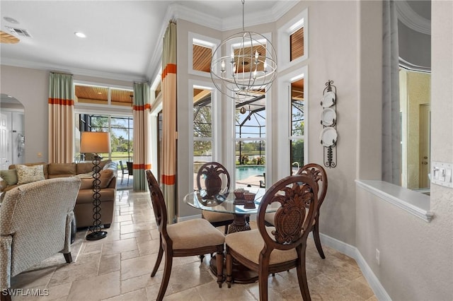 dining room with stone tile floors, baseboards, visible vents, arched walkways, and crown molding