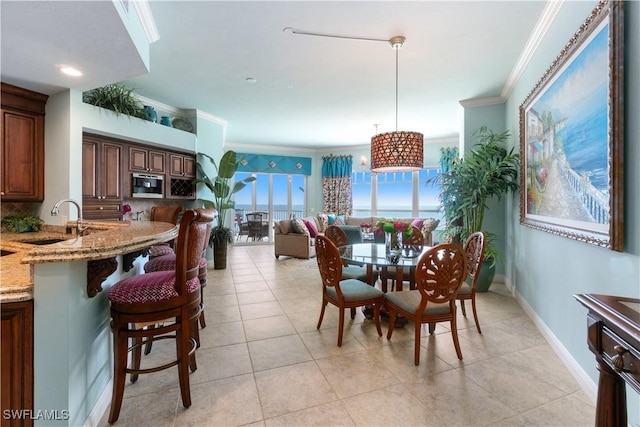 dining area featuring baseboards, light tile patterned floors, and crown molding