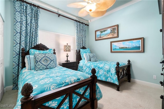 bedroom featuring carpet floors, ceiling fan, baseboards, and ornamental molding