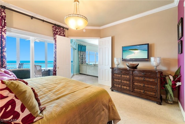 carpeted bedroom with ornamental molding and baseboards