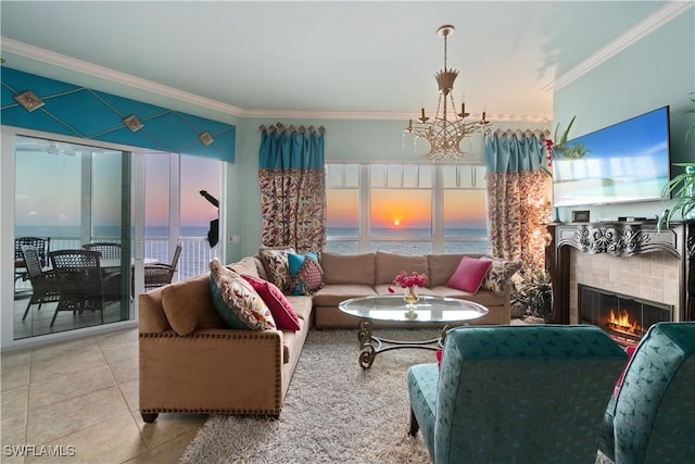 tiled living area with an inviting chandelier, crown molding, and a tile fireplace