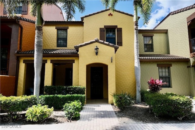 view of front of home with a tile roof and stucco siding