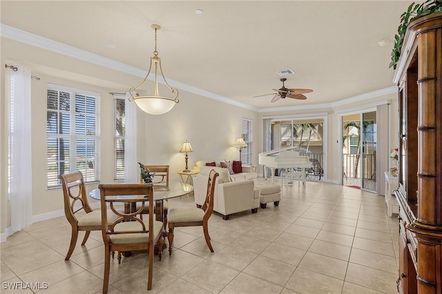 dining space featuring crown molding, plenty of natural light, light tile patterned flooring, and visible vents