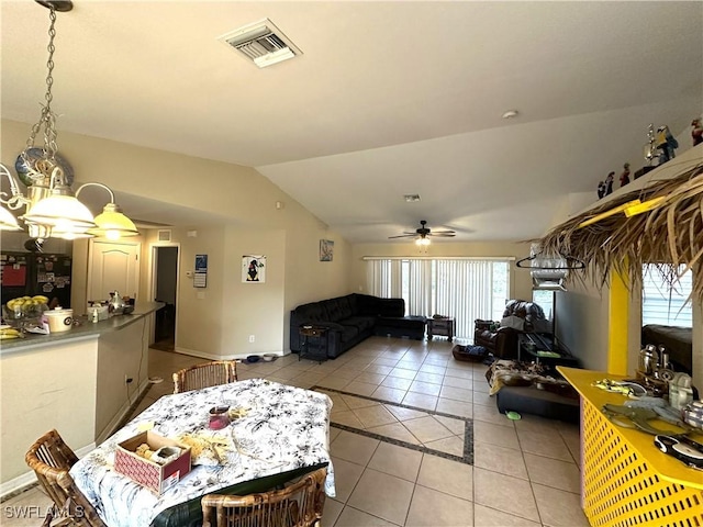 living area with lofted ceiling, light tile patterned floors, visible vents, and a ceiling fan