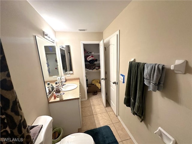 full bathroom featuring toilet, vanity, tile patterned flooring, and visible vents