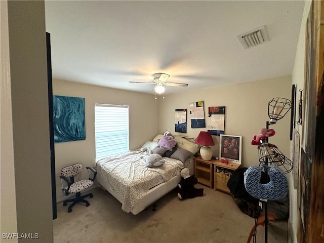 carpeted bedroom featuring visible vents and ceiling fan