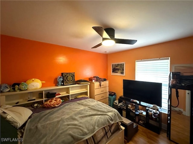 bedroom featuring a ceiling fan and wood finished floors