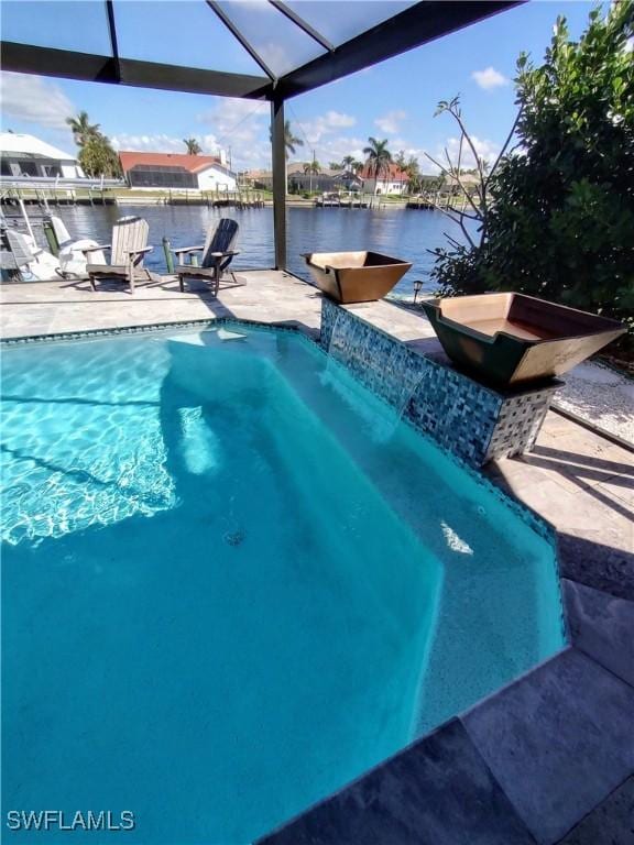 outdoor pool with a patio, a lanai, and a water view