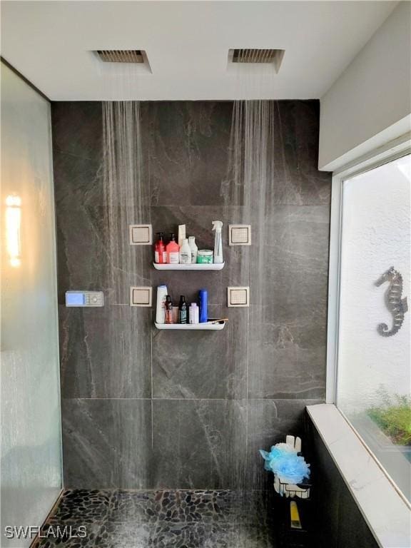 full bath featuring a tile shower