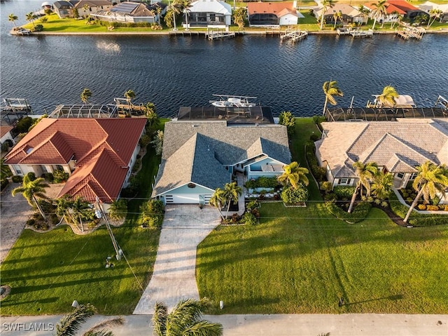 drone / aerial view with a residential view and a water view