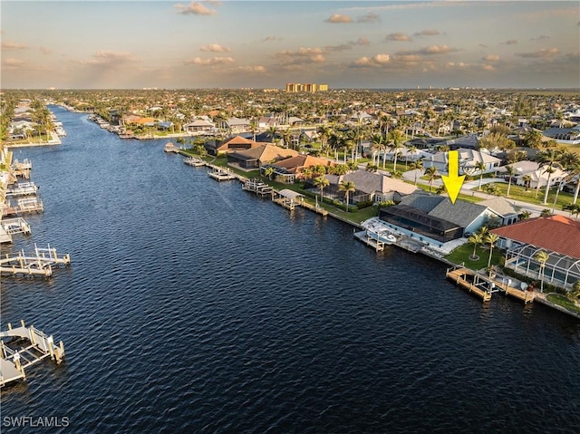 bird's eye view with a residential view and a water view