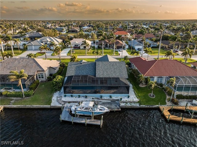 birds eye view of property featuring a residential view and a water view