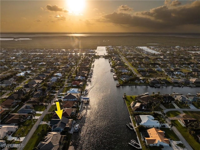 birds eye view of property with a water view and a residential view