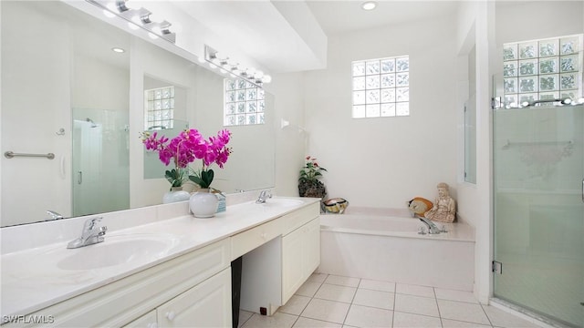 full bath featuring double vanity, a sink, tile patterned flooring, a shower stall, and a bath