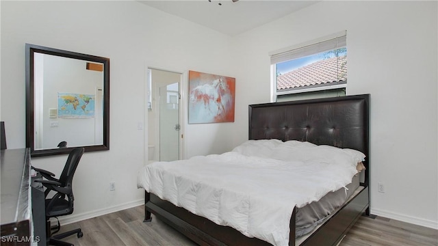 bedroom with baseboards and wood finished floors