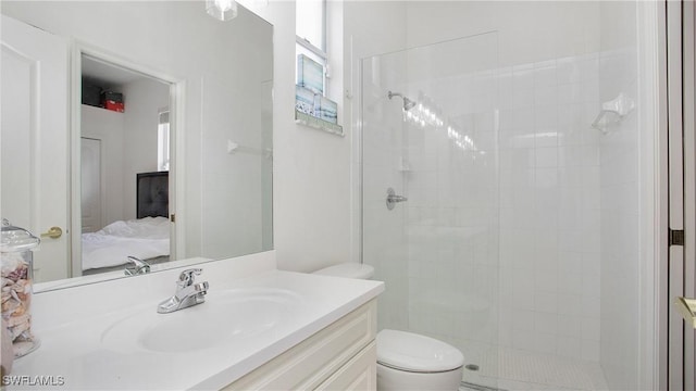 ensuite bathroom with vanity, tiled shower, ensuite bath, and toilet