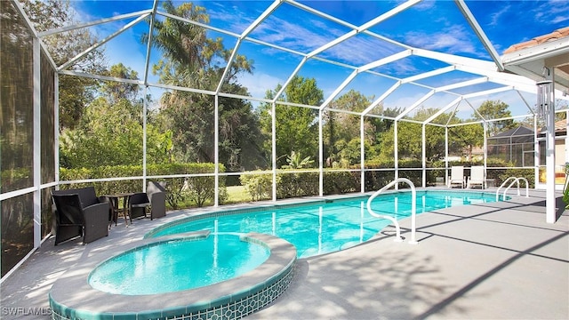 view of pool with a pool with connected hot tub, a patio, and a lanai