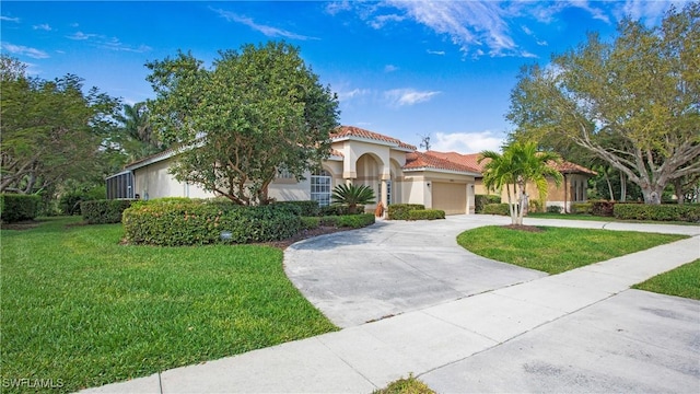 mediterranean / spanish home featuring concrete driveway, a tile roof, an attached garage, a front yard, and stucco siding