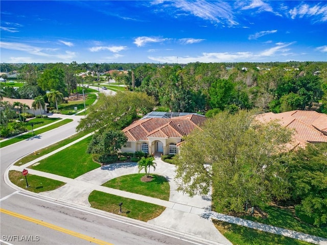 bird's eye view with a wooded view