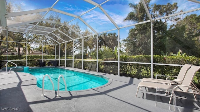 outdoor pool with a patio area and a lanai