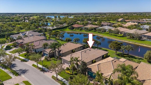 drone / aerial view with a residential view and a water view