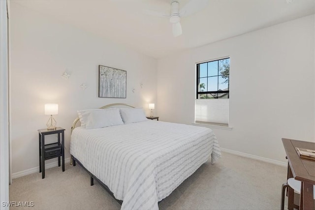 bedroom featuring ceiling fan, baseboards, and light carpet