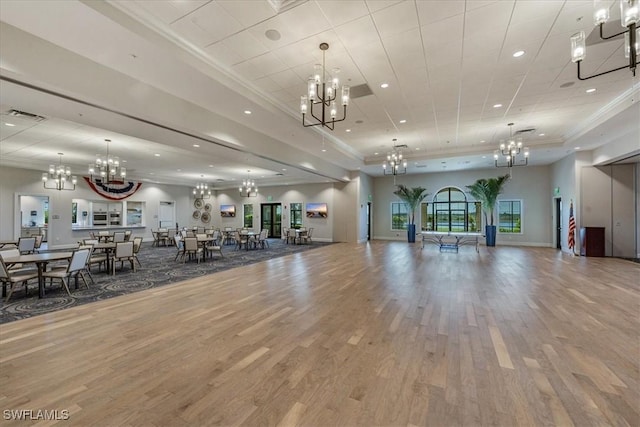 exercise room featuring visible vents, a chandelier, and crown molding