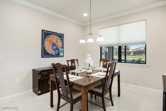 dining room featuring baseboards, ornamental molding, and light tile patterned flooring