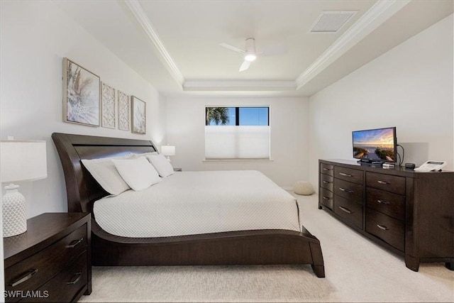 bedroom with visible vents, light carpet, ornamental molding, a ceiling fan, and a raised ceiling