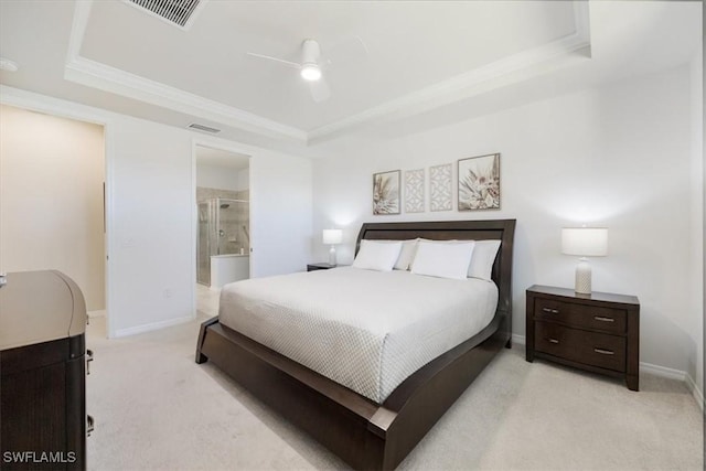 bedroom with visible vents, connected bathroom, baseboards, light carpet, and a raised ceiling