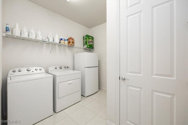 laundry room with light tile patterned floors, laundry area, and independent washer and dryer