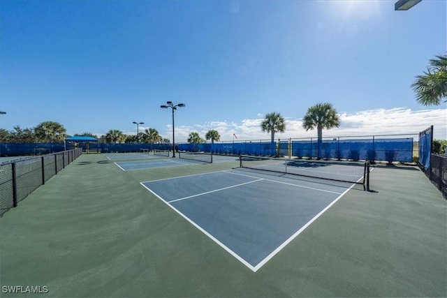 view of tennis court with fence