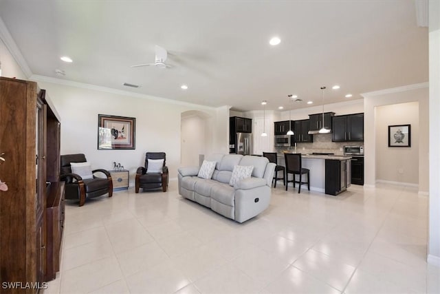 living area with light tile patterned floors, recessed lighting, a ceiling fan, and ornamental molding