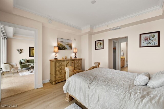 bedroom with baseboards, light wood-style flooring, visible vents, and crown molding