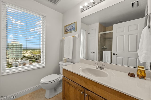 bathroom with toilet, a stall shower, vanity, and visible vents