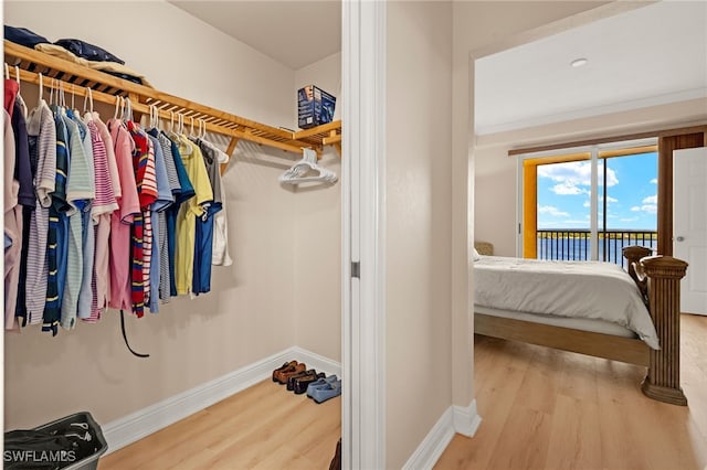interior space featuring access to outside, baseboards, and wood finished floors