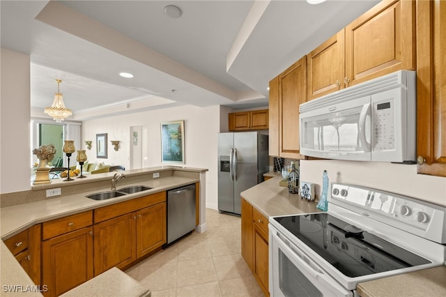 kitchen featuring light tile patterned floors, stainless steel appliances, light countertops, brown cabinetry, and a sink