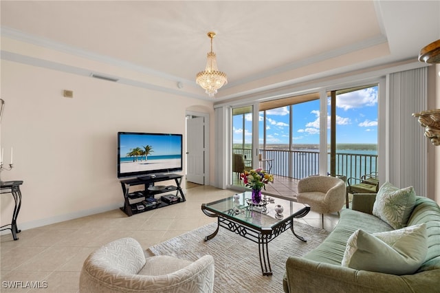 living room with a tray ceiling, crown molding, baseboards, and light tile patterned floors