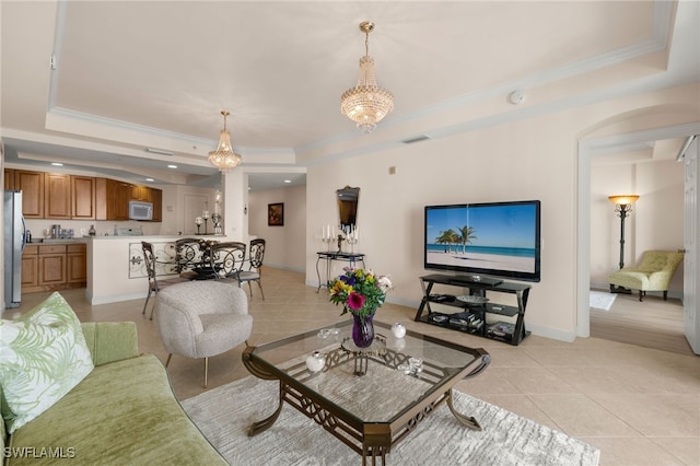 living room featuring a tray ceiling, light tile patterned floors, visible vents, ornamental molding, and baseboards