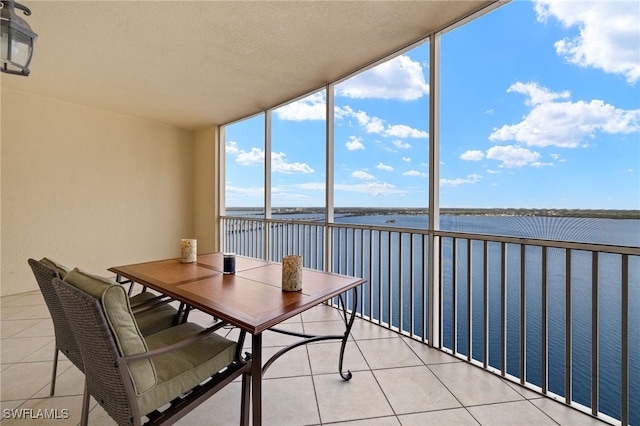 sunroom / solarium with a water view
