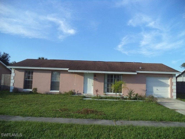 ranch-style house with a garage, a front lawn, and stucco siding