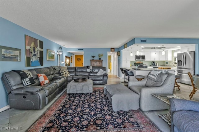 living room with visible vents and a textured ceiling