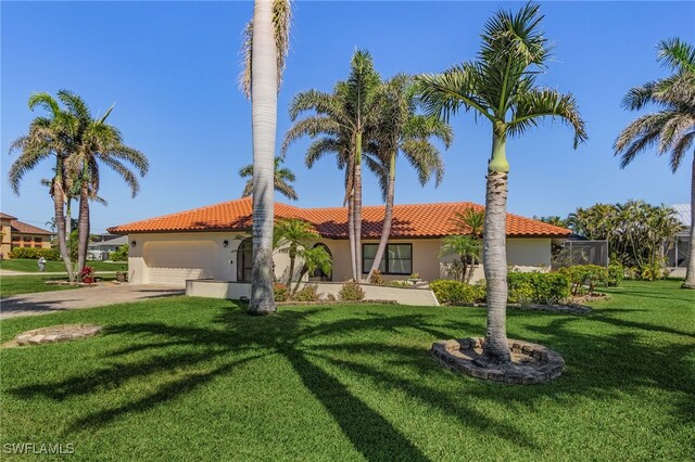 5305 SW 25th Ct, Cape Coral, FL 33914 - mediterranean / spanish-style house featuring a tile roof, an attached garage, driveway, a front lawn, and stucco siding
